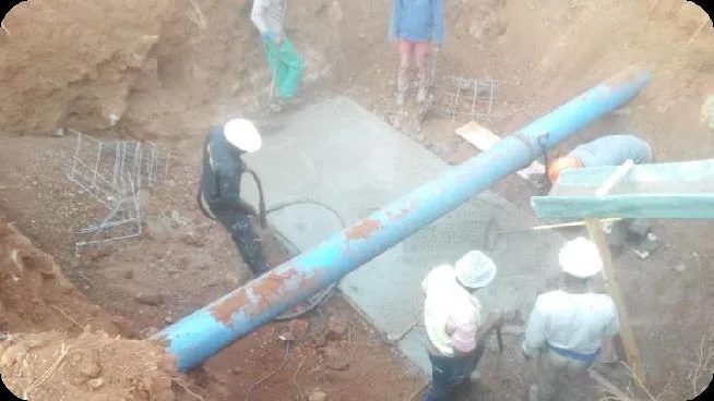 Team installing a large diameter pipeline in an open excavated trench